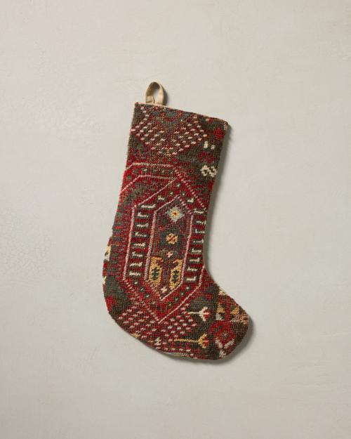 This stocking has a one-sided design and hangs with the toe facing right.