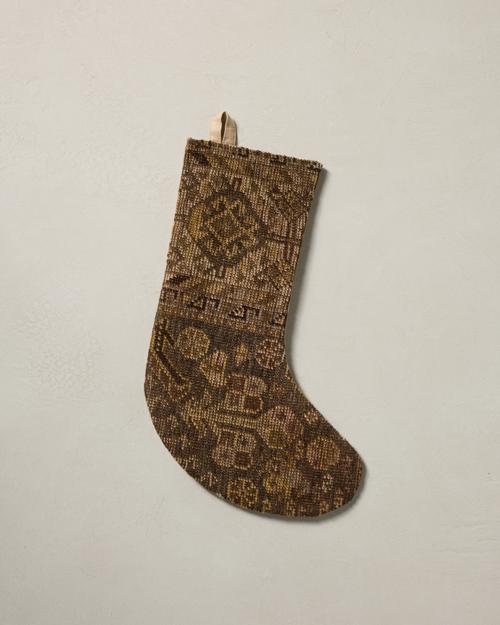 This stocking has a one-sided design and hangs with the toe facing right.