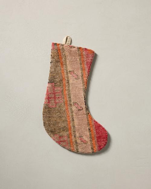 This stocking has a one-sided design and hangs with the toe facing right.