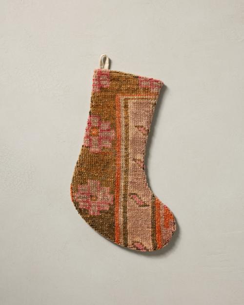 This stocking has a one-sided design and hangs with the toe facing right.