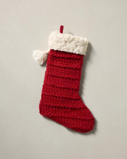 This stocking has a one-sided design and hangs with the toe facing right.