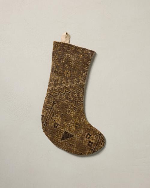 This stocking has a one-sided design and hangs with the toe facing right.