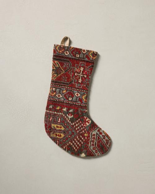 This stocking has a one-sided design and hangs with the toe facing right.