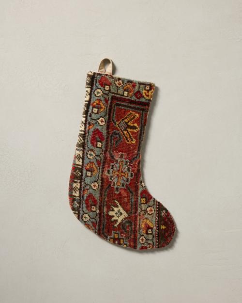 This stocking has a one-sided design and hangs with the toe facing right.