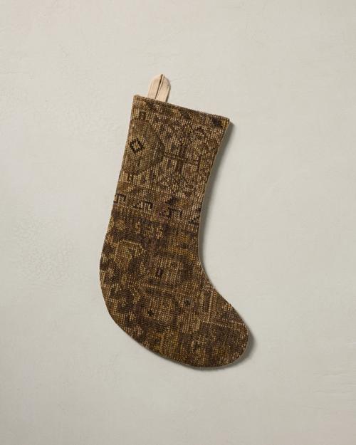 This stocking has a one-sided design and hangs with the toe facing right.