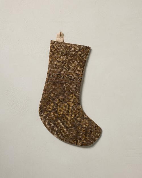 This stocking has a one-sided design and hangs with the toe facing right.