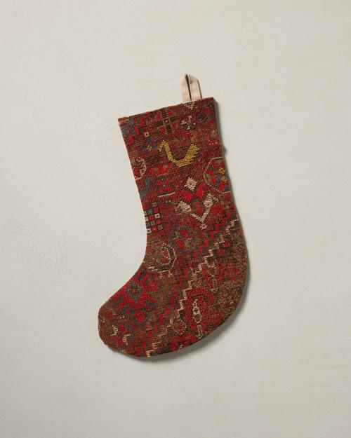 This stocking has a one-sided design and hangs with the toe facing left
