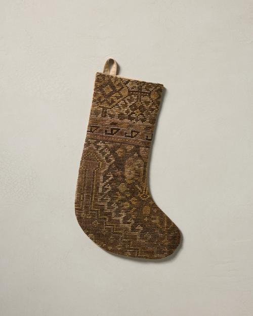 This stocking has a one-sided design and hangs with the toe facing right.