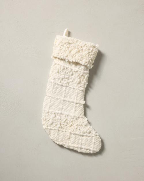 This stocking has a one-sided design and hangs with the toe facing right.